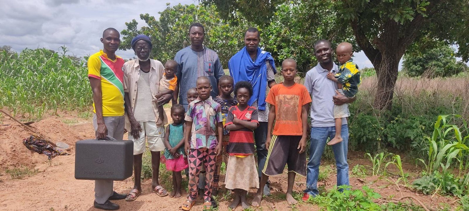 Farmers and project team with a drone in the field